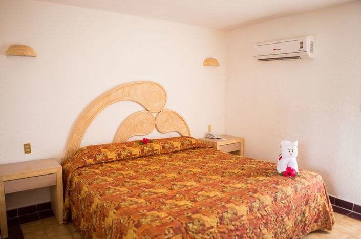 Hotel Qualton Ixtapa Habitación estándar con vista a los jardines, equipada con una cama King size, ideal para parejas que viajan de vacaciones en Ixtapa Zihuatanejo
